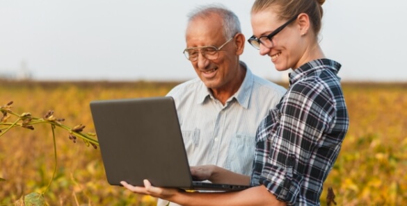 A father and daughter using a laptop