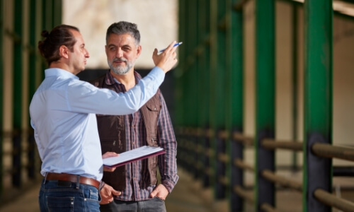 Two men talking on a farm